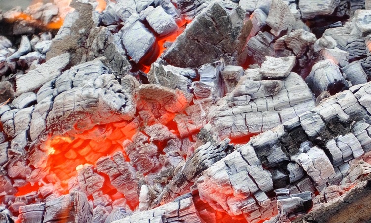 ash covered logs with intermitent red embers