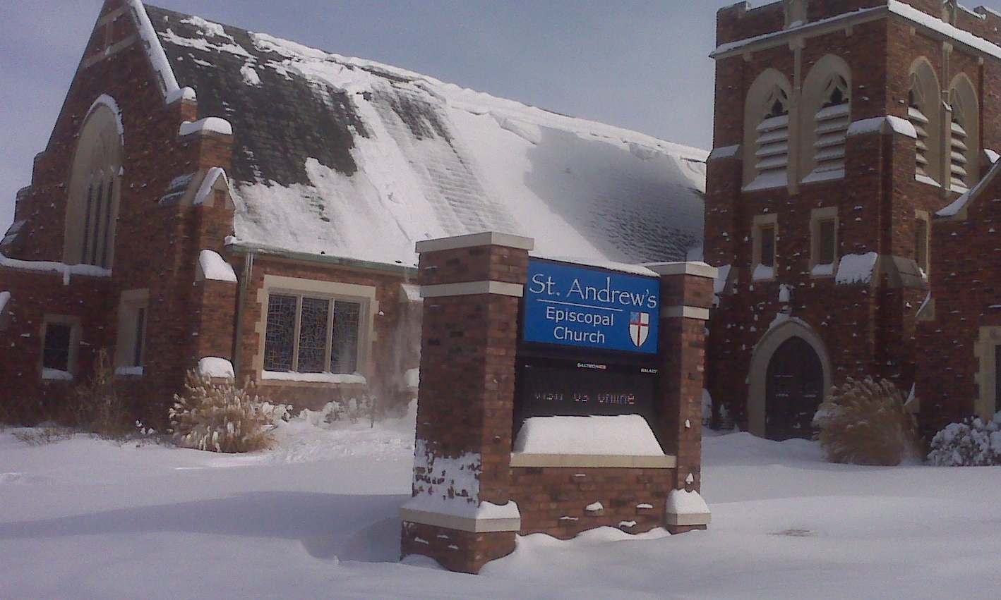 Photo of the exterior of a brick church building with a sign reading St. Andrew's Episcopal Church in front